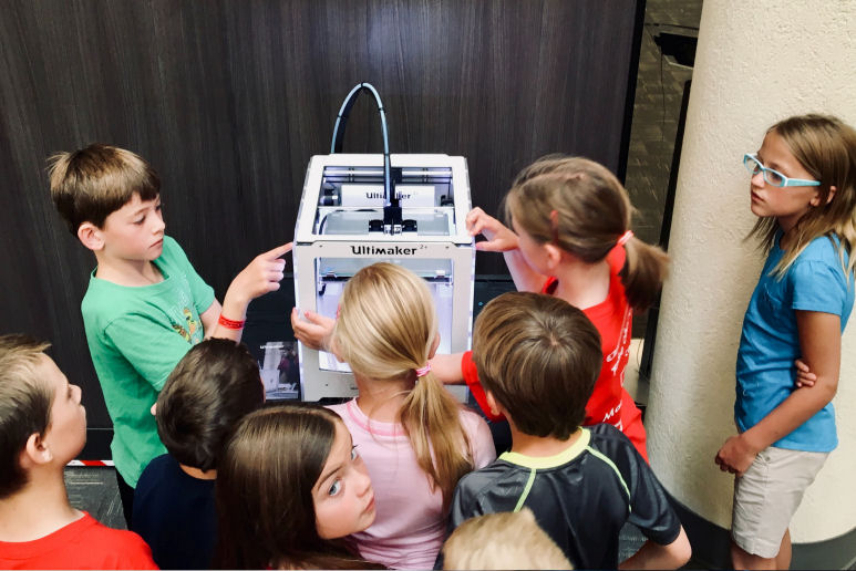 children exploring a 3D printer